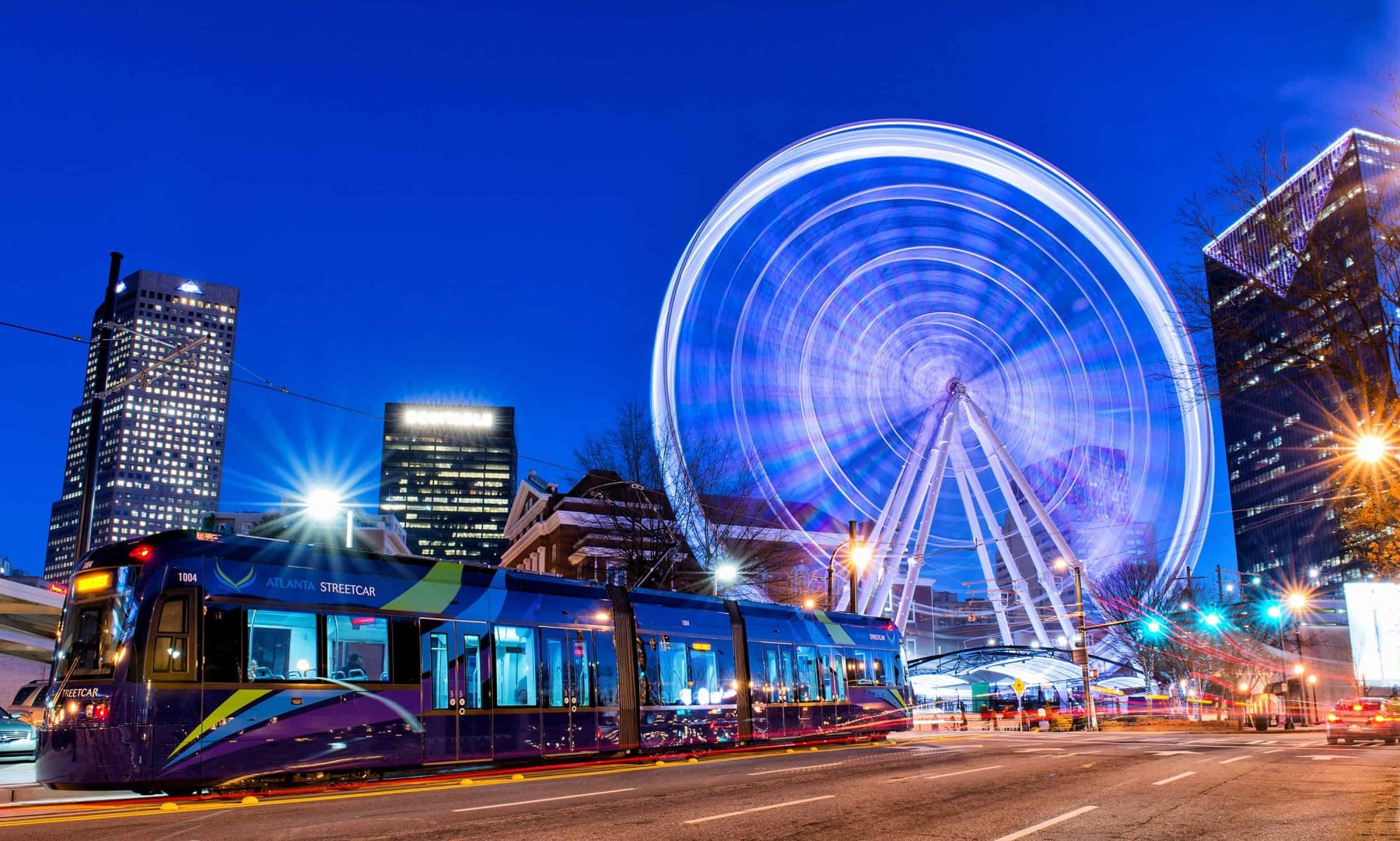 The Atlanta Streetcar and the Skyview Atlanta Ferris Wheel at blue hour.