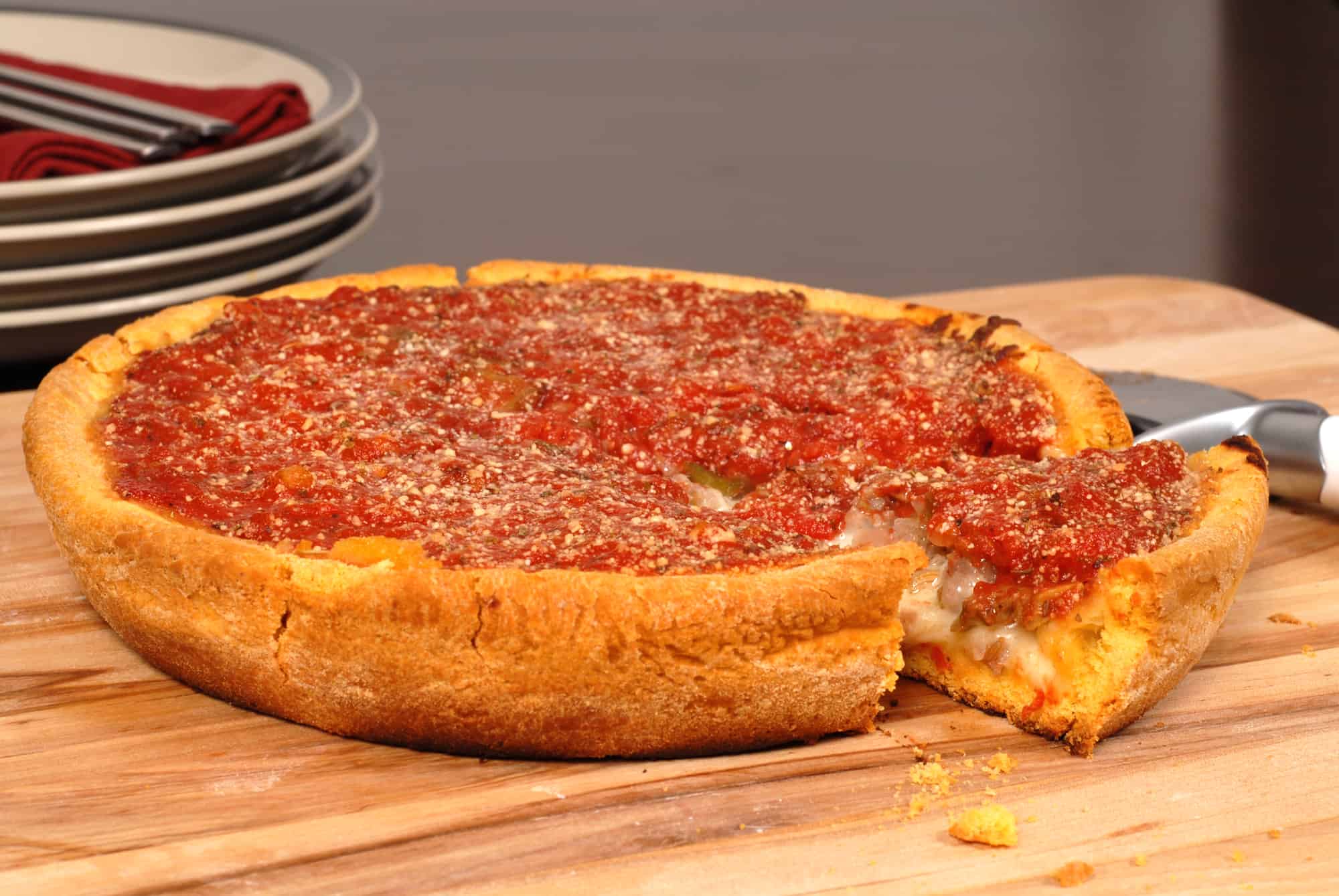 Chicago style deep dish pizza with a piece cut out