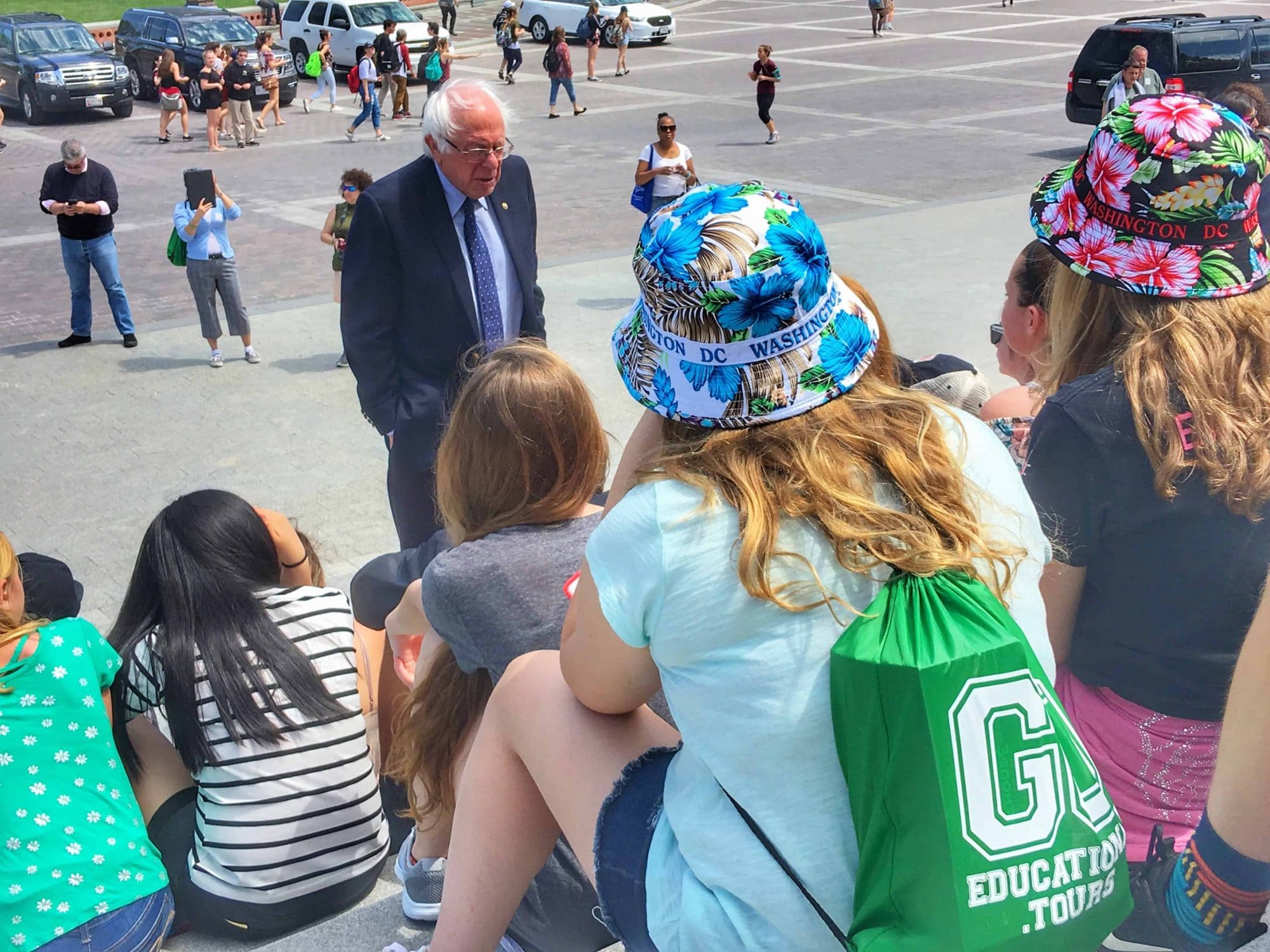 Senator Bernie Sanders on the steps of the US Capitol meeting with students on a class trip