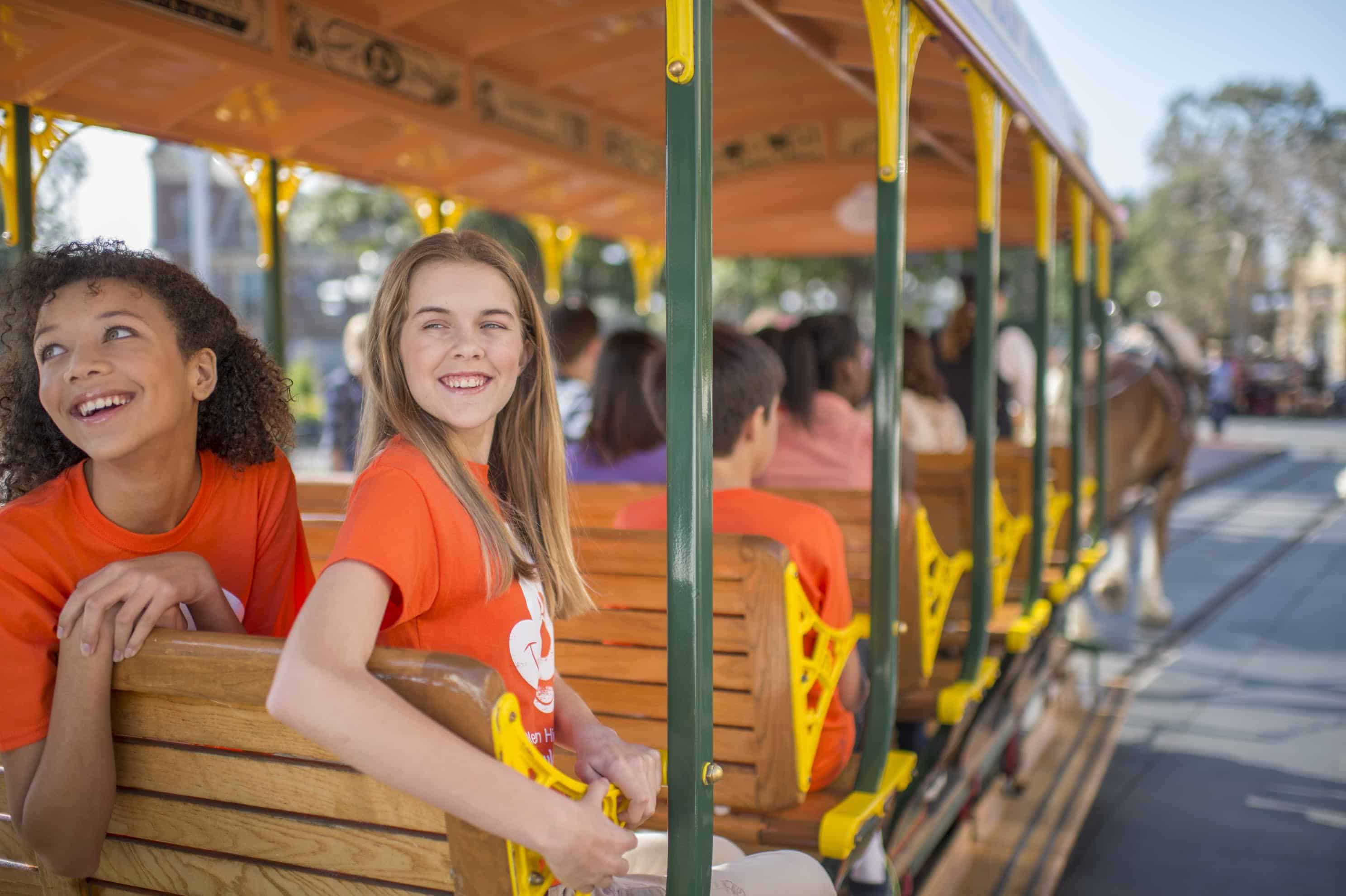 Kids on a Disney Trolley- image by Walt Disney World. 