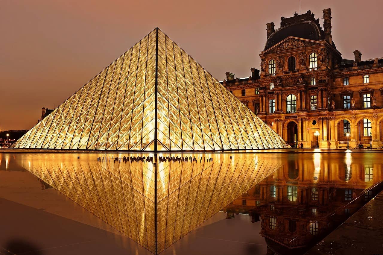 Louvre Pyramid illuminated at night in Paris