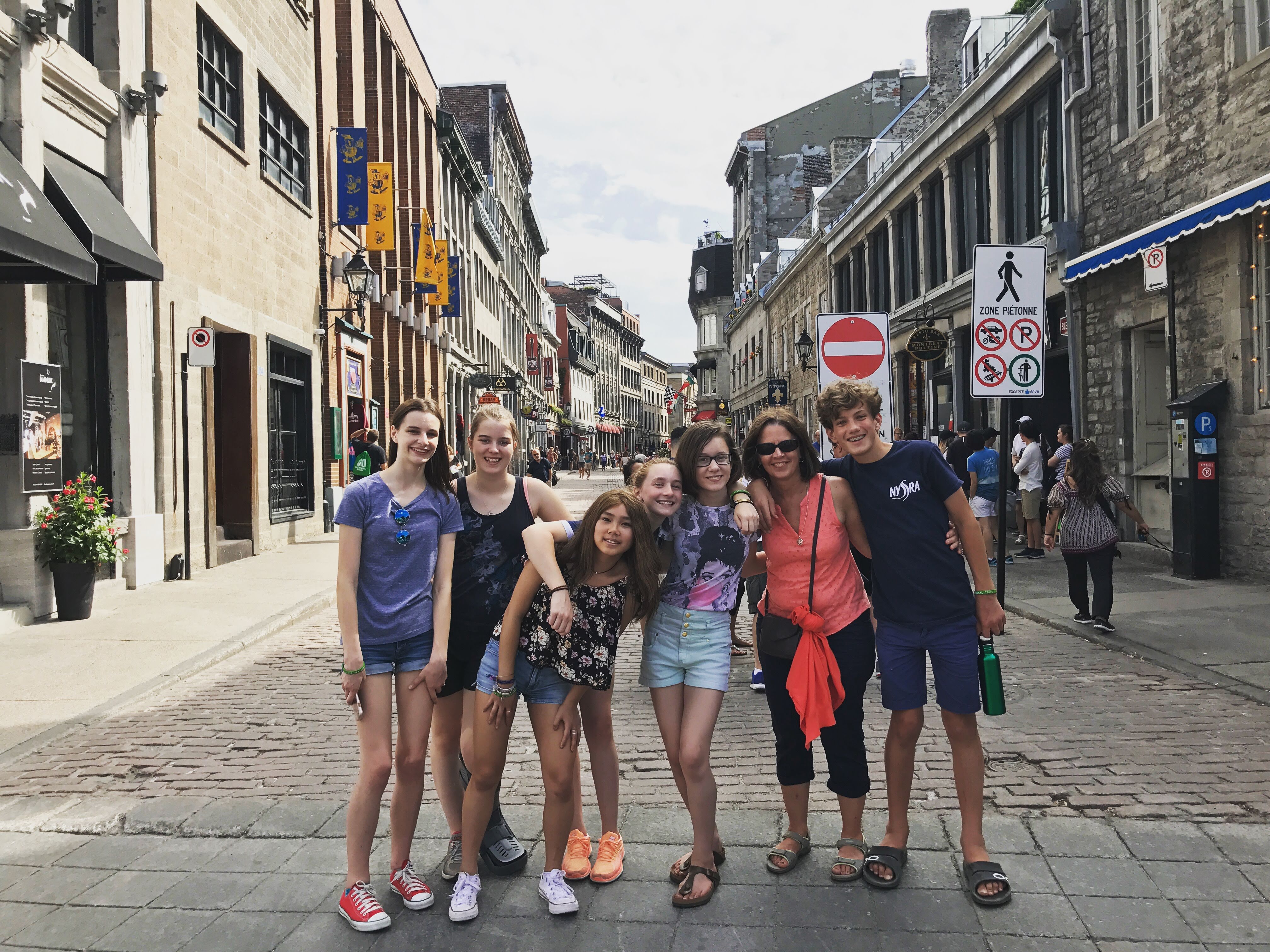 Students posing on a cobblestone street in Old Montreal. 