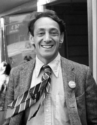 Harvey Milk portrait similing in a suit. 