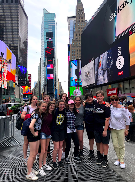 Students posing in Times Square, New York City with GO Educational Tours.