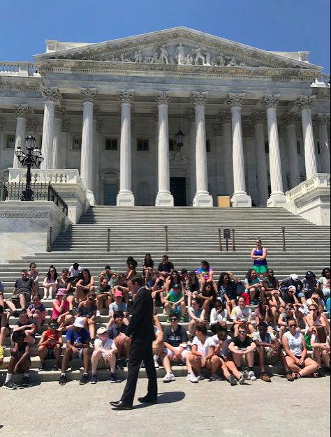 Senator speaking to a group of students at the United States Capitol building. 